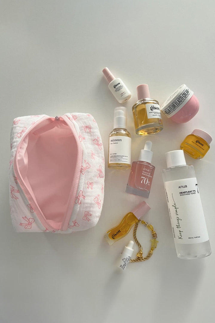 Trousse de maquillage matelassée à fermeture éclair et nœud papillon