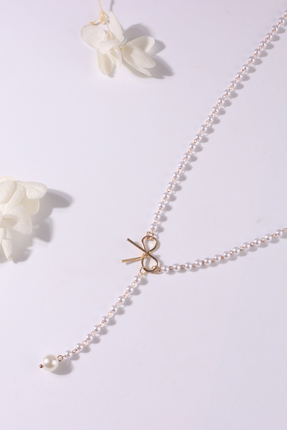 Collier en chaîne de perles avec nœud plaqué