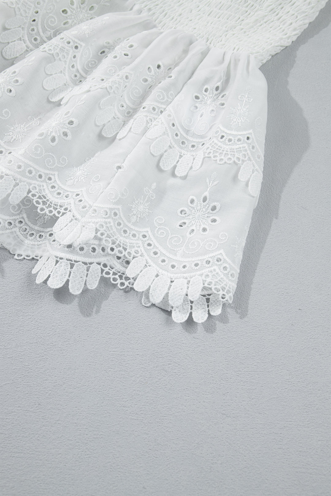 Chic White Sleeveless Smocked Lace Peplum Top