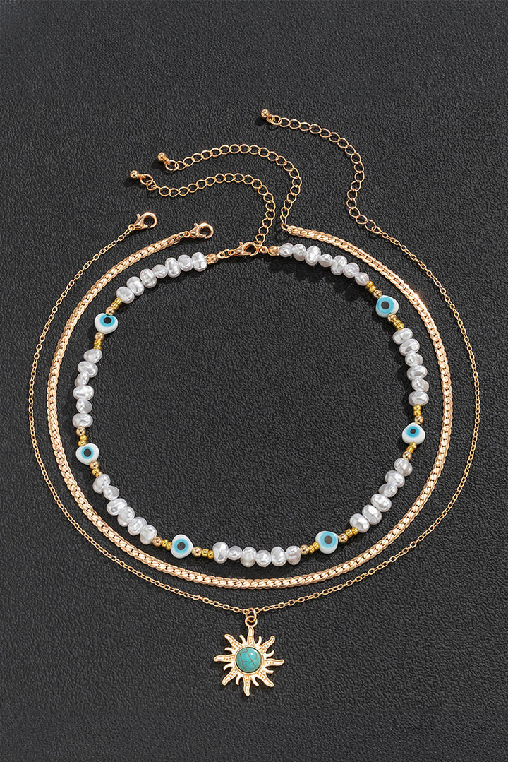 Collier pendentif multicouche en perles turquoises et perles de soleil