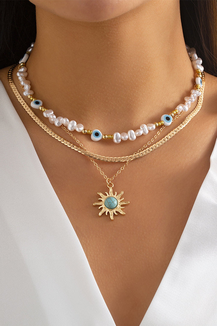 Collier pendentif multicouche en perles turquoises et perles de soleil