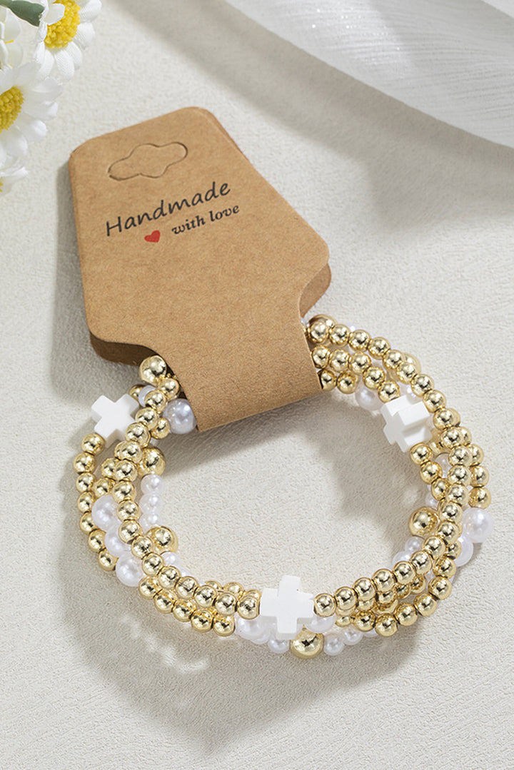 Bracelet élastique multicouche en perles avec décor de croix
