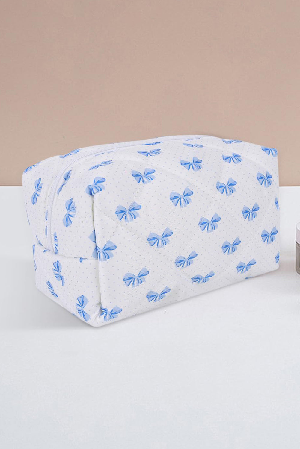Trousse de maquillage matelassée à fermeture éclair et nœud papillon